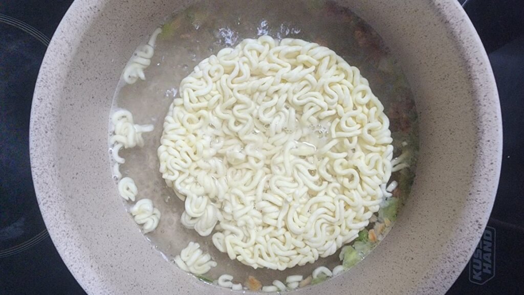 Noodles boiling in water during Chapagetti cooking
