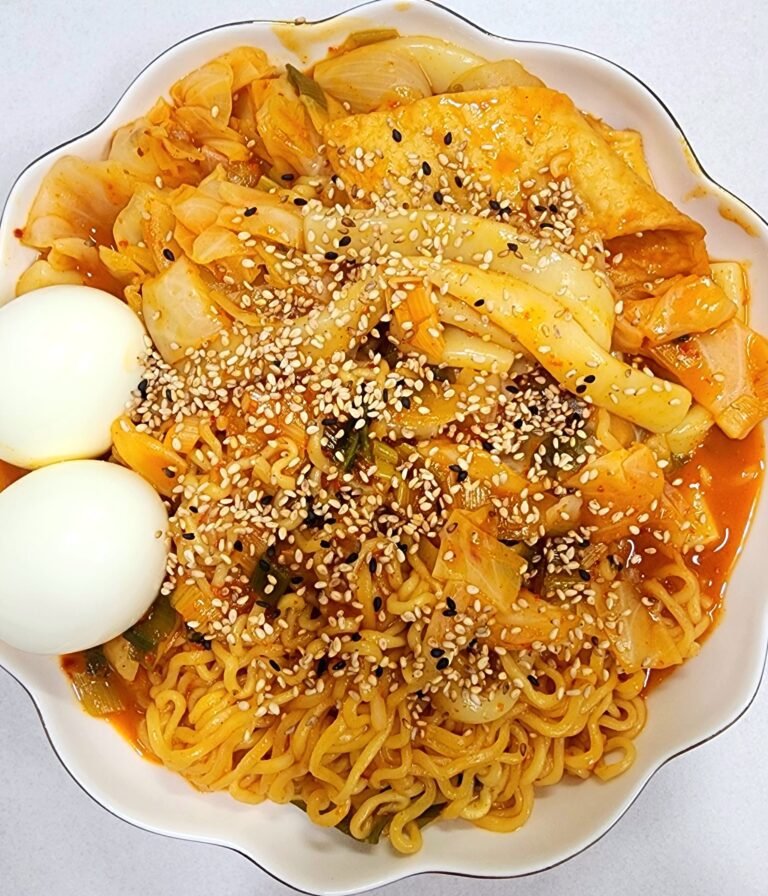 Finished one-pan rabokki(Ramen Tteokbokki) served in a deep bowl with sesame seeds