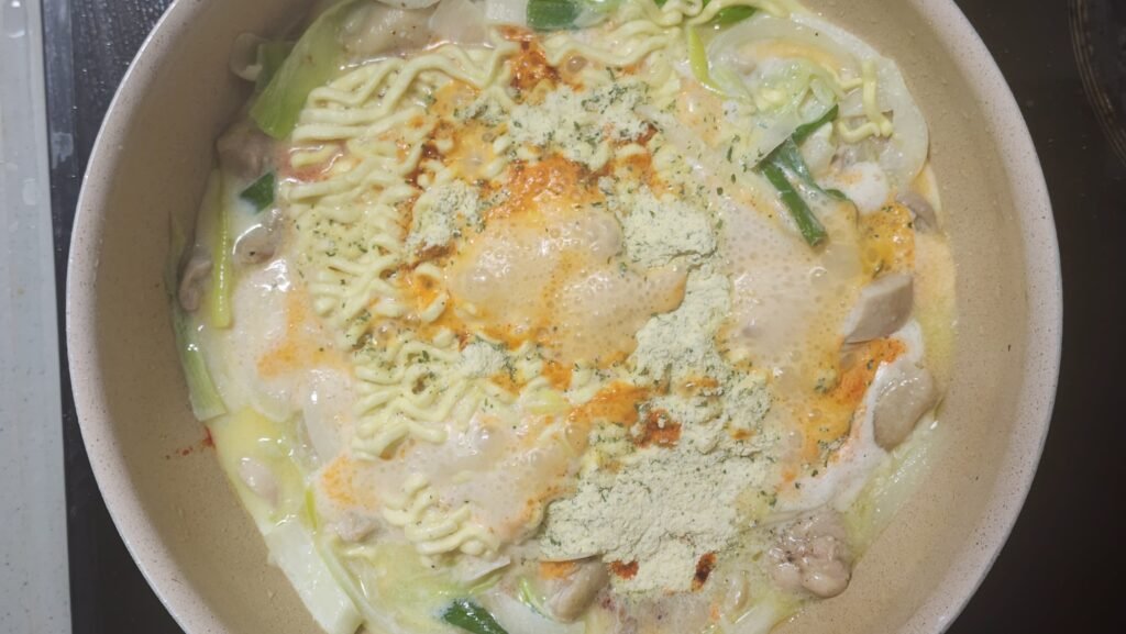 Cooking the ramen noodles with Rosé Buldak sauce and chicken bouillon powder in the milk.