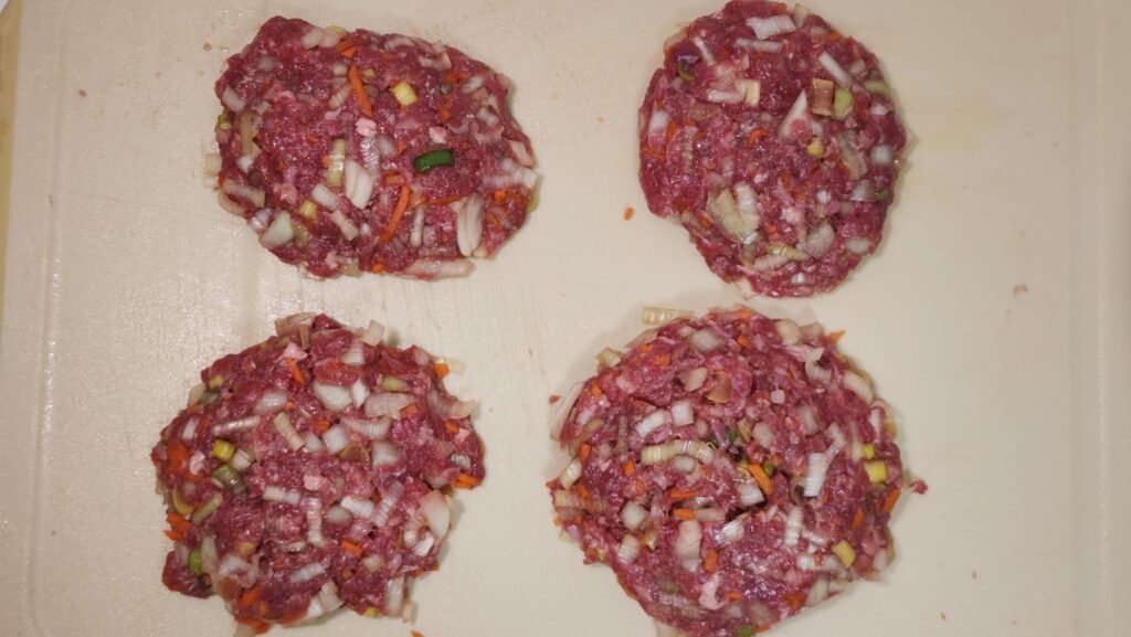 Shaping the beef and vegetable mixture into tteokgalbi patties.