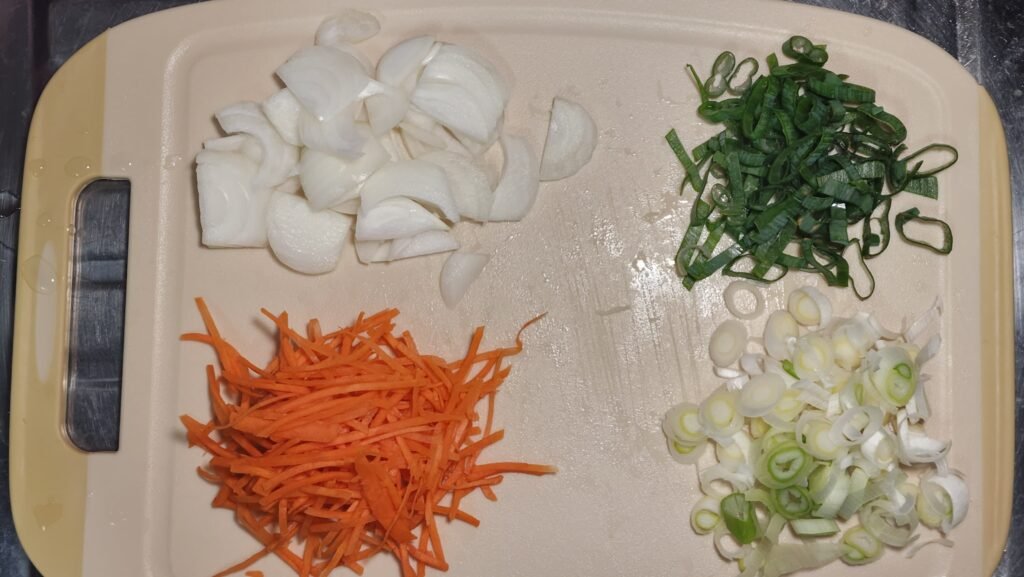 Preparing sliced onion, Korean green onion, and thin carrot matchsticks for beef bulgogi.
