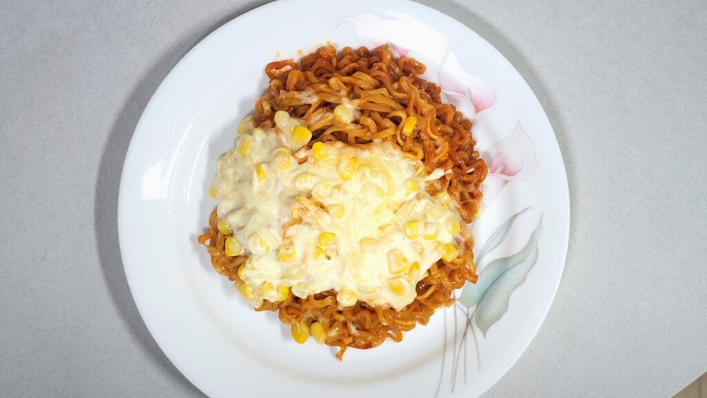 Finished 1-bowl microwave corn cheese Buldak ramen with melted mozzarella